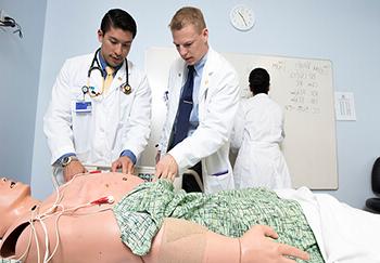 Students examining mannequin at the Clinical Skills Simulation Center